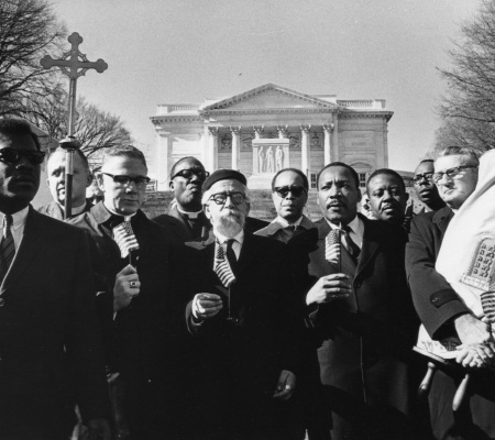 UNITED STATES - FEBRUARY 07:  "Leaders of the protest, holding flags, from left Bishop James Shannon, Rabbi Abraham Heschel, Dr. Martin Luther King and Rabbi Maurice Eisendrath." Tomb of the Unknown Soldier, Arlington Cemetery, February 6, 1968. Published February 7, 1968.  (Photo by Charles Del Vecchio/Washington Post/Getty Images)